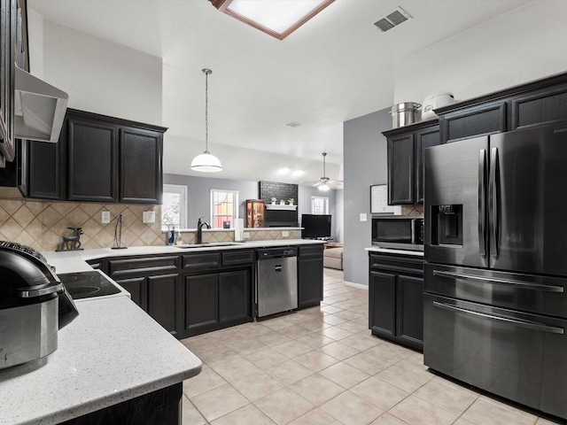 kitchen with ceiling fan, sink, pendant lighting, decorative backsplash, and appliances with stainless steel finishes