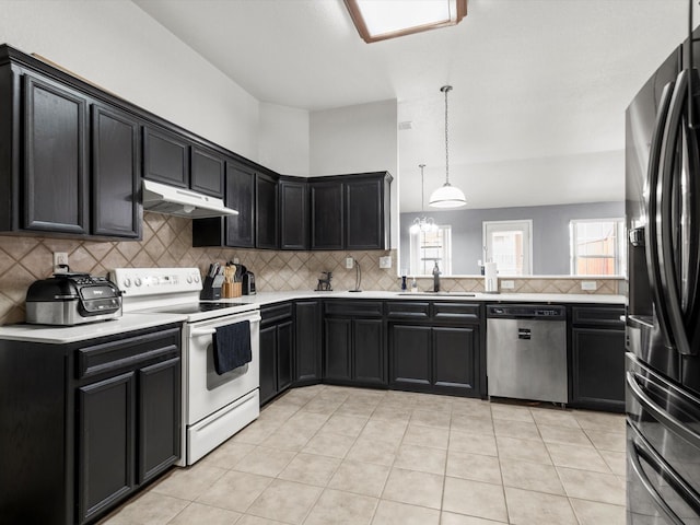 kitchen featuring decorative backsplash, decorative light fixtures, stainless steel appliances, and sink