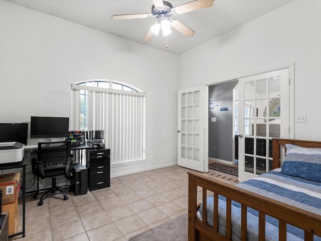 tiled bedroom featuring french doors and ceiling fan