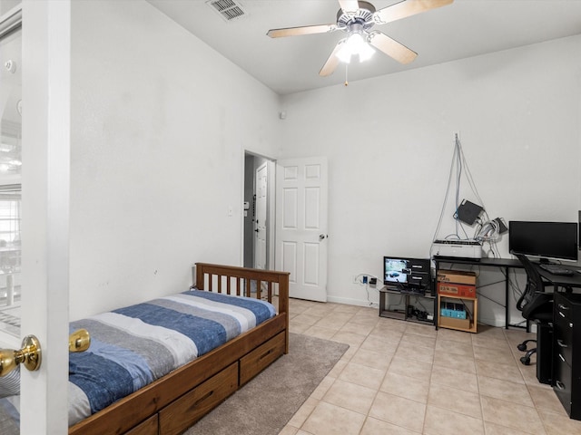 tiled bedroom featuring ceiling fan