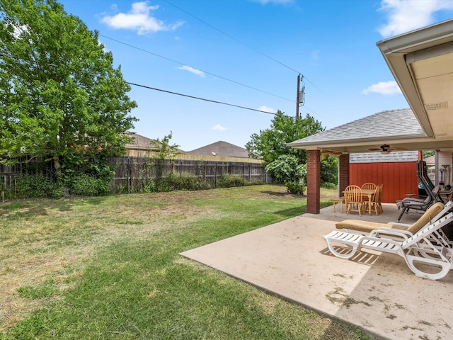 view of yard featuring ceiling fan and a patio area