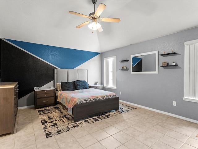 bedroom featuring ceiling fan, light tile patterned flooring, and lofted ceiling