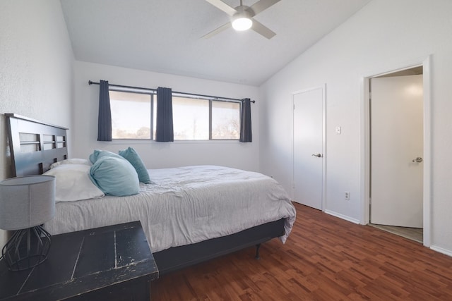 bedroom featuring ceiling fan, dark hardwood / wood-style floors, and vaulted ceiling