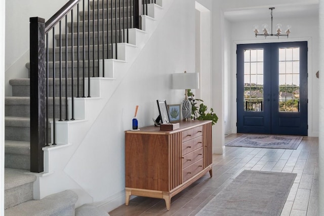 foyer entrance with french doors and a notable chandelier