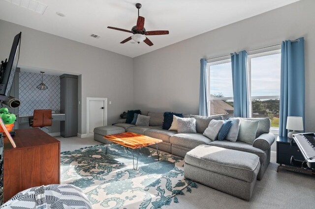 carpeted living room featuring ceiling fan