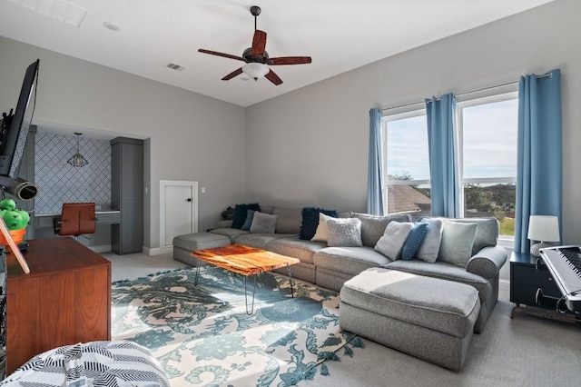 living room with light colored carpet and ceiling fan