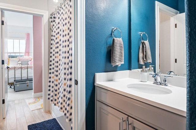 bathroom featuring vanity and a shower with shower curtain