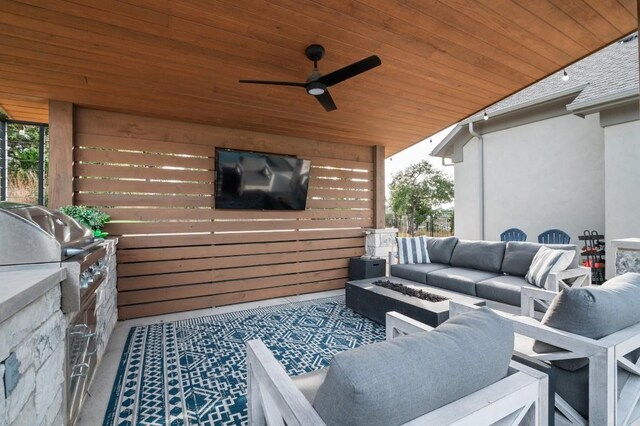 view of patio / terrace featuring outdoor lounge area, ceiling fan, a grill, and an outdoor kitchen