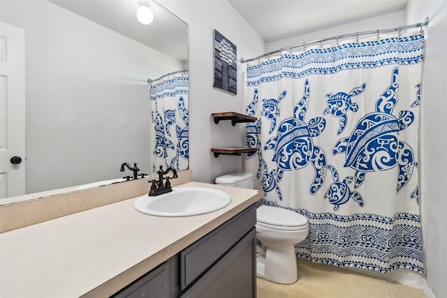 bathroom featuring vanity, toilet, and walk in shower