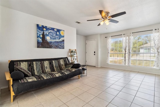 tiled living room with ceiling fan