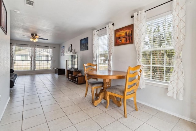 dining space featuring ceiling fan and light tile patterned flooring