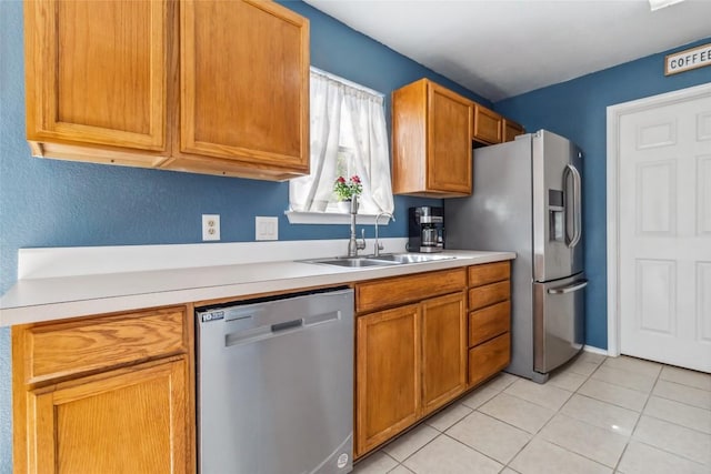 kitchen with sink, light tile patterned floors, and appliances with stainless steel finishes