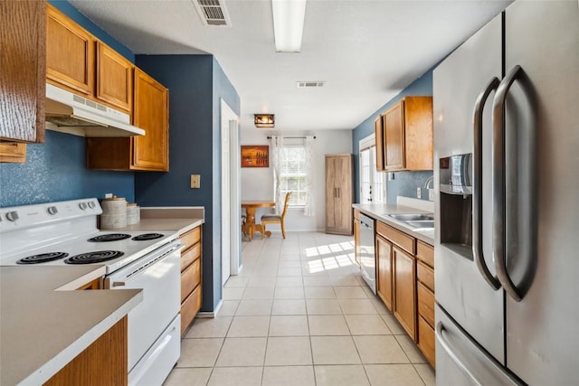 kitchen with light tile patterned flooring, sink, and stainless steel appliances