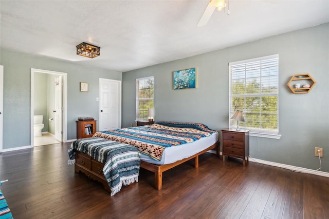 bedroom with ensuite bath, ceiling fan, and dark hardwood / wood-style floors