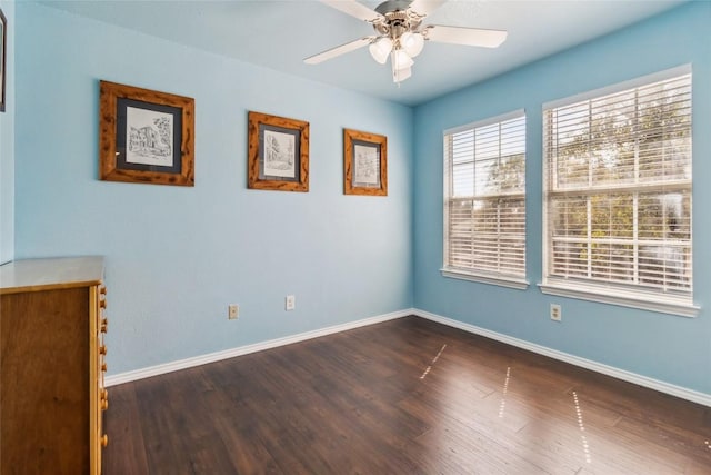 unfurnished room with ceiling fan and dark wood-type flooring