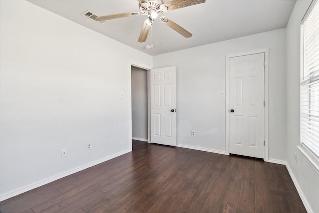 unfurnished bedroom with ceiling fan and dark hardwood / wood-style flooring