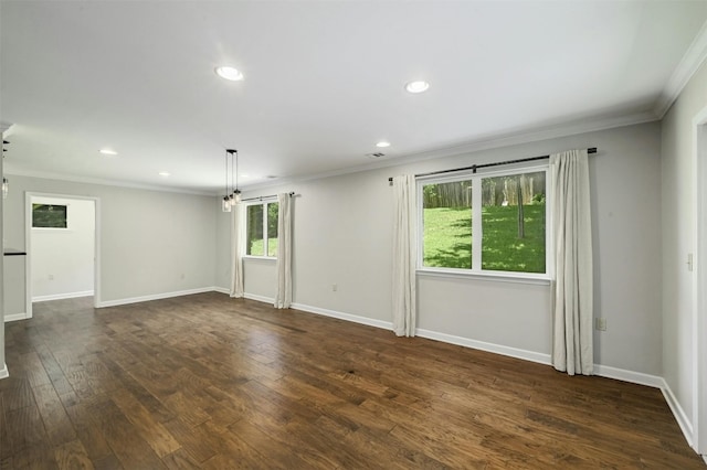 spare room featuring crown molding and dark wood-type flooring