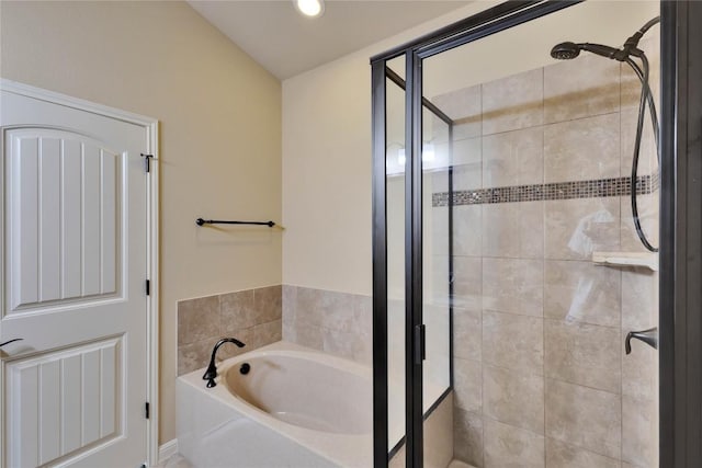 bathroom featuring separate shower and tub