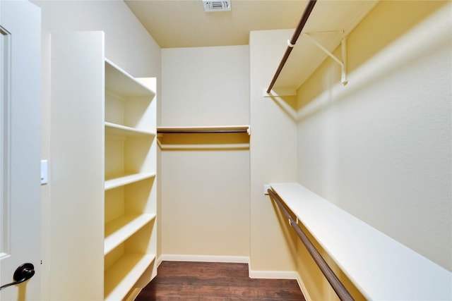 walk in closet featuring dark wood-type flooring