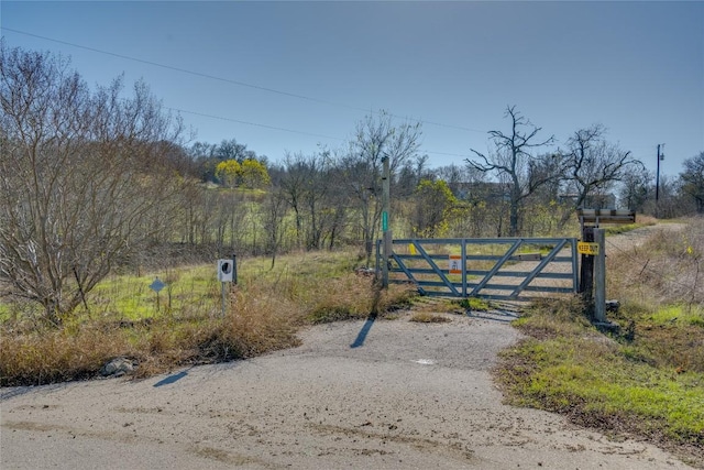 view of gate with a rural view