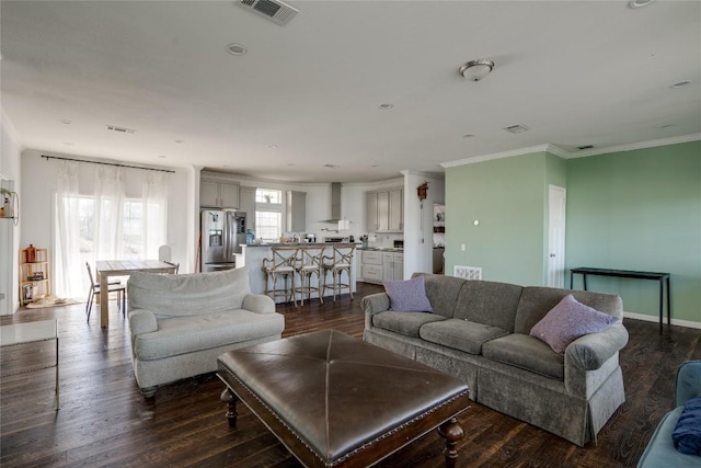 living room with dark hardwood / wood-style floors and ornamental molding