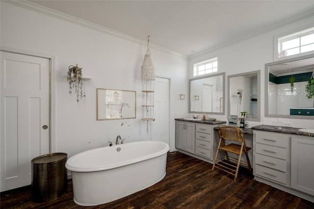 15701 Forest Glenn Cv, Del Valle, TX 78617 - full bath with crown molding, vanity, a freestanding bath, and wood finished floors