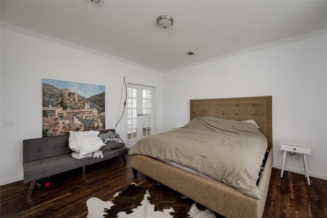 15701 Forest Glenn Cv, Del Valle, TX 78617 - bedroom featuring ornamental molding, wood finished floors, french doors, and baseboards