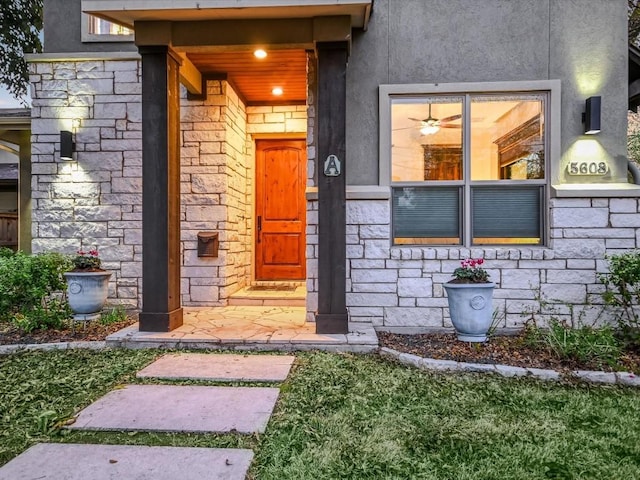 view of exterior entry with stone siding and stucco siding