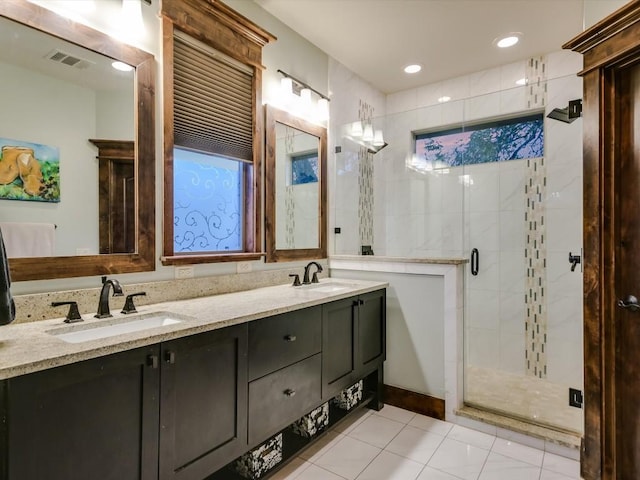 bathroom with tile patterned floors, vanity, and an enclosed shower