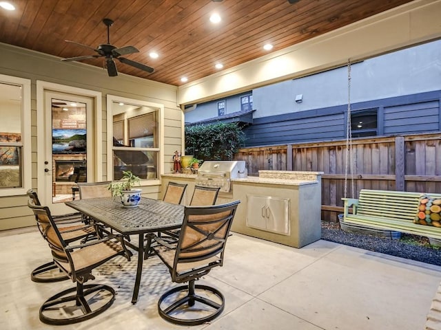 view of patio with ceiling fan and area for grilling