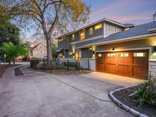 5608 Clay Ave Unit A, Austin, TX 78756 - view of front facade featuring concrete driveway, an attached garage, board and batten siding, and roof with shingles