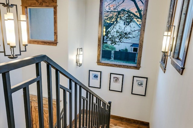 stairway with baseboards and wood finished floors