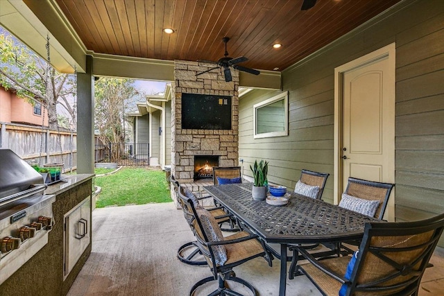 5608 Clay Ave Unit A, Austin, TX 78756 - view of patio / terrace with an outdoor stone fireplace, outdoor dining area, and a ceiling fan