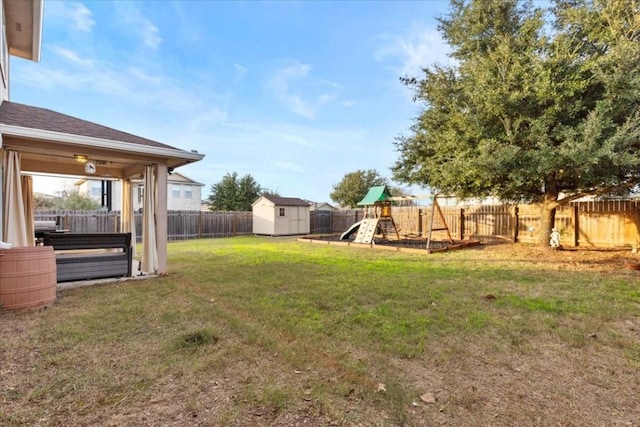 view of yard with a playground and a storage shed