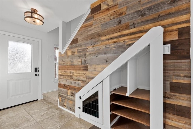 foyer featuring wood walls