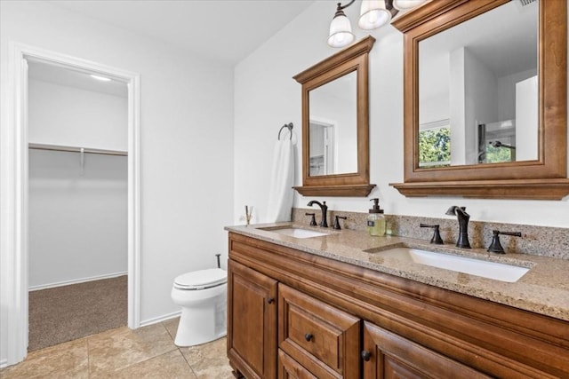 bathroom featuring tile patterned floors, vanity, and toilet