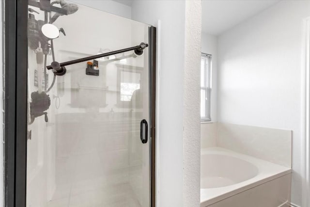 bathroom featuring separate shower and tub