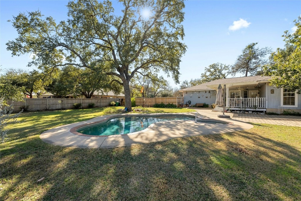 view of swimming pool featuring a lawn and a wooden deck