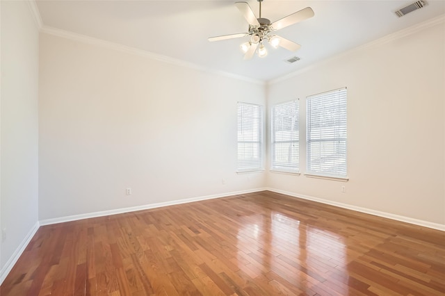 empty room featuring ceiling fan, wood-type flooring, and crown molding