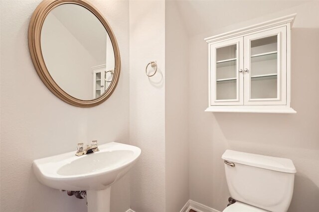 bathroom featuring sink and toilet