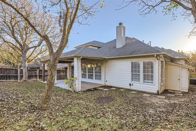 back of property with a patio