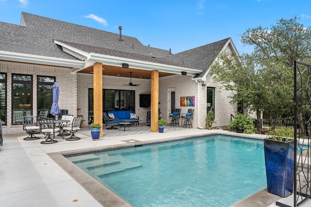 outdoor pool featuring a ceiling fan and a patio