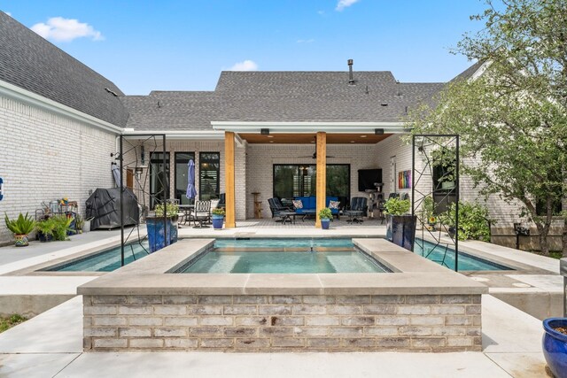 view of pool featuring a patio area, an in ground hot tub, ceiling fan, and grilling area