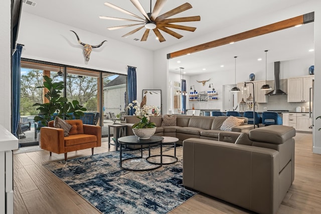 living room featuring light wood-style flooring, visible vents, and recessed lighting