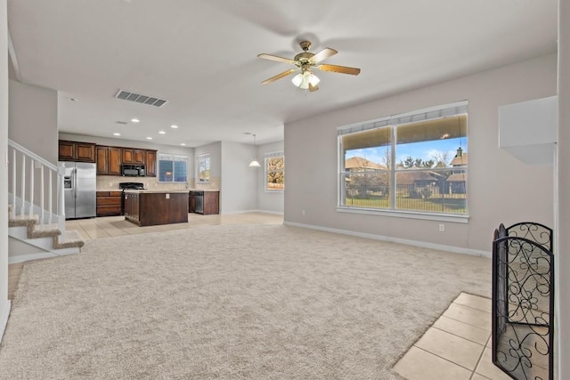 living room featuring light carpet and ceiling fan