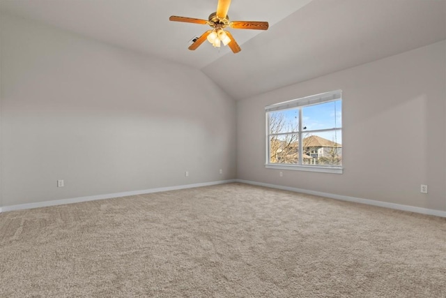 spare room with carpet, ceiling fan, and lofted ceiling