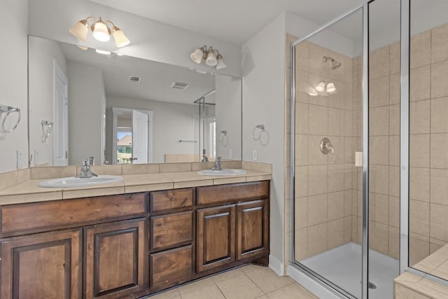 bathroom featuring tile patterned flooring, vanity, and a shower with shower door