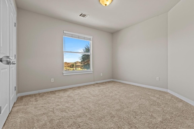 unfurnished room featuring light colored carpet