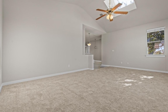 carpeted empty room featuring vaulted ceiling and ceiling fan