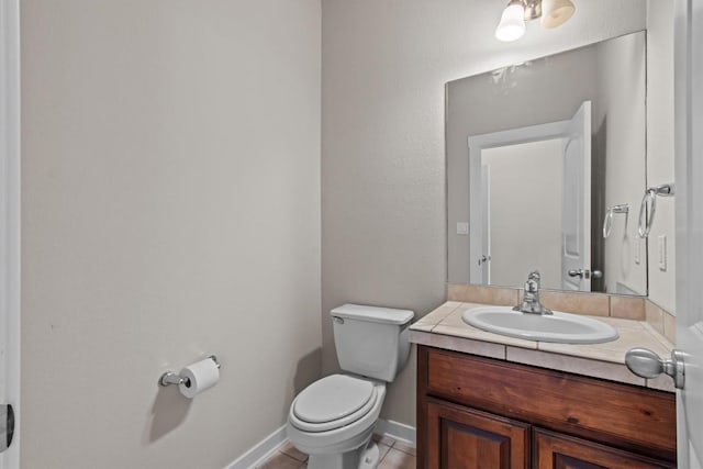 bathroom featuring tile patterned floors, vanity, and toilet